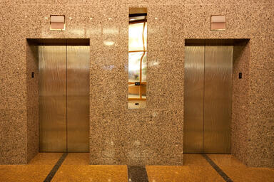 Stainless Steel Elevator Doors in Seastone Finish with Champagne pattern
