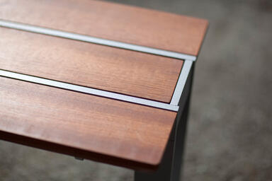 Apex Bench shown with FSC&reg; 100% hardwood slats, Aluminum Texture powdercoated fr