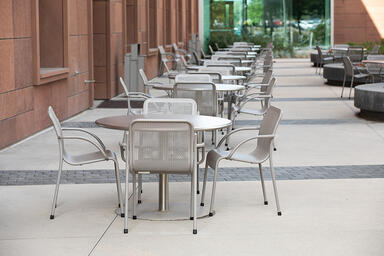 Column Tables with 42&rdquo; round table tops in Stainless Steel with Sandstone finish