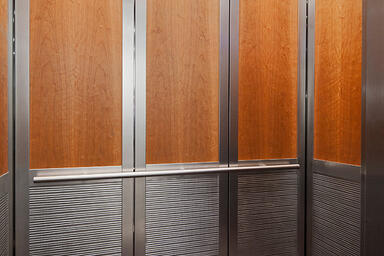 LEVELc-2000N Elevator Interior with insets in custom American Cherry wood veneer