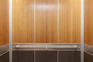 LEVELe-105 Elevator Interior with upper panels in custom bamboo wood veneer