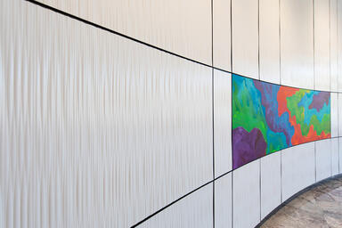 Curved wall panels in Bonded Quartz, White, with Kalahari pattern in vertical