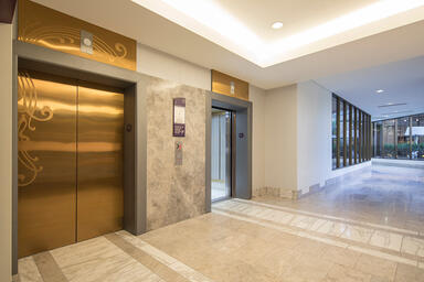 Elevator doors shown in Fused Bronze with Satin finish and custom Eco-Etch