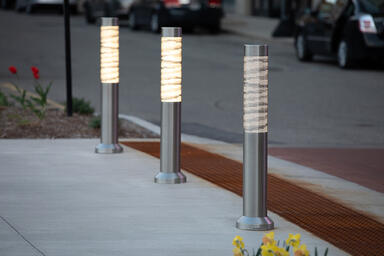 Light Column Bollards in Stainless Steel with Satin finish shown in illuminated 