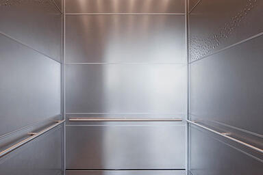 LEVELe-104 Elevator Interior with panels in Stainless Steel with Sandstone