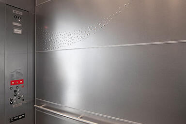 LEVELe-104 Elevator Interior with panels in Stainless Steel with Sandstone 