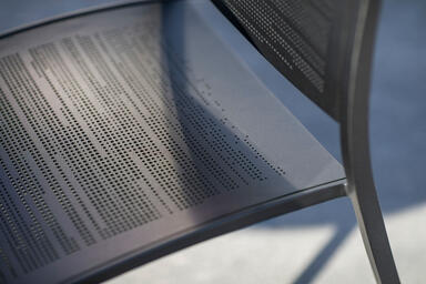 Detail of Avivo Chair in Black Texture powdercoat with Riva perforation pattern