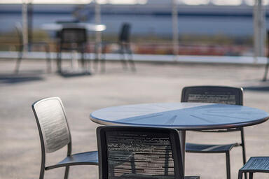 Avivo Chairs shown with Black Texture powdercoat and Riva perforation pattern