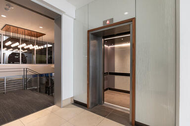 Elevator lobby wall with ViviGraphix Graphica glass in Reflect configuration