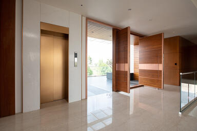 Elevator Doors, transom, and door jambs in Fused Bronze with Seastone finish
