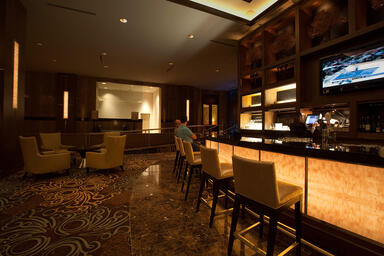 Bar front and column accents in backlit ViviStone Honey Onyx 