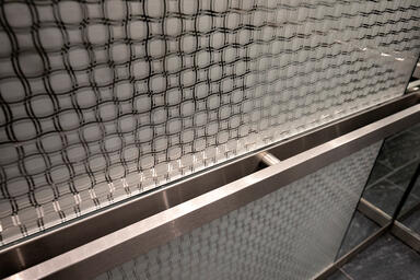 Elevator interior panels with ViviStrata Layers glass in Reflect configuration w