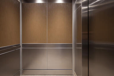 LEVELe-106 Elevator Interior with panels in Bonded Bronze with Natural Patina