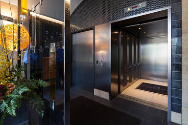 Elevator doors shown in Fused Nickel Silver with Linen finish 