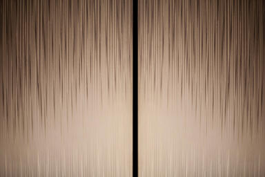 Elevator doors in Fused Nickel Bronze with Satin finish and Silkworm Eco-Etch 