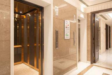 LEVELc-2000 Elevator Interior with upper panels in Bronze Mirror Glass; lower pa