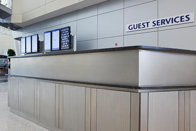 Ticket counter panels in Stainless Steel with Sandstone finish and Chardonnay 