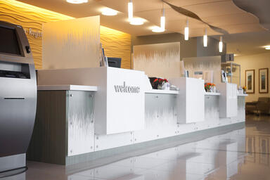 Reception desk shown in ViviGraphix Gradiance glass with custom Switchgrass 