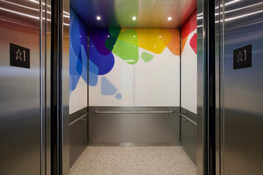 Elevator interior panels with ViviSpectra Spectrum glass in Reflect
