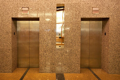 Elevator Doors in Stainless Steel with Seastone finish and Champagne Impression 