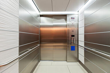LEVELe-103 Elevator Interior with panels in Stainless Steel with Seastone