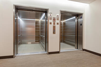 LEVELe-103A Elevator Interiors; Capture panels in Stainless Steel with Seastone 