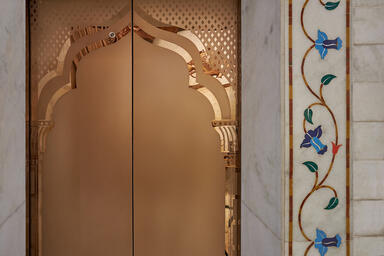 Detail of Elevator door in Fused Bronze with Satin finish and custom Eco-Etch