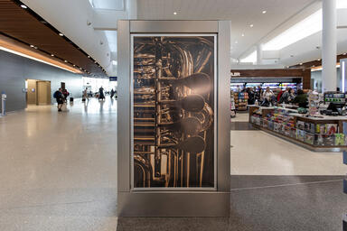 Signage frame in Stainless Steel with Seastone finish at Louis Armstrong New Or