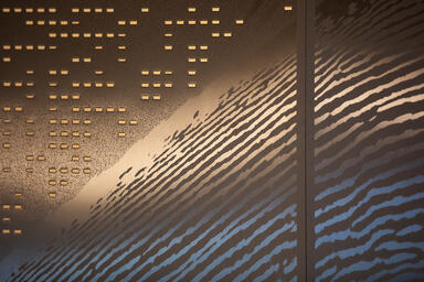 Detail of backlit panels in Fused Nickel Bronze with Satin finish, custom Eco-Et