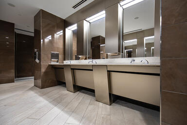 Restroom vanity in Fused White Gold with Seastone finish at Louis Armstrong New 