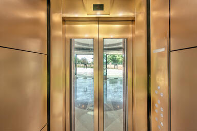 LEVELe-105 Elevator Interior with panels in Fused Bronze with Linen finish