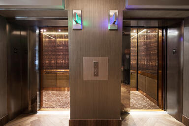 LEVELe-106 Elevator Interiors with Capture panels in ViviStone Honey Onyx