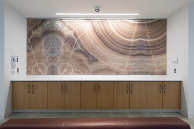 Wall panels in ViviStone Cream Onyx glass with custom interlayer and Standard