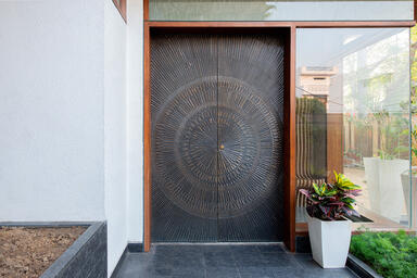 Doors shown in Bonded Bronze with Dark Patina and Solstice pattern at Private Re