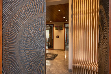 Doors shown in Bonded Bronze with Dark Patina and Solstice pattern at Private Re