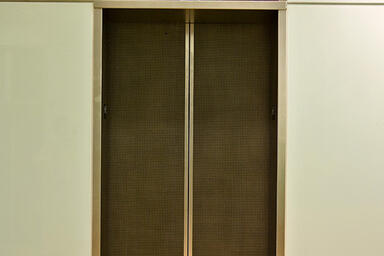 Elevator doors and transoms shown in Bonded Nickel Silver with Dark patina