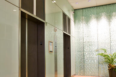 Elevator doors and transoms shown in Bonded Nickel Silver with Dark patina