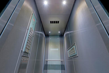 LEVELe-105 Elevator Interior with customized panel layout; panels in Bonded Alum