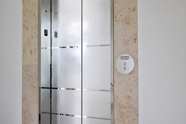 Elevator door skins in Stainless Steel with Mirror finish and custom Eco-Etch