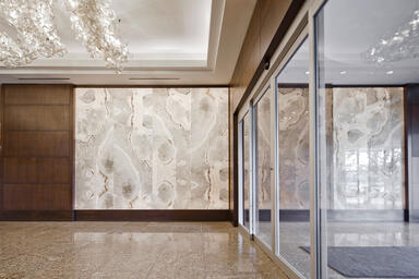 Backlit wall shown in ViviStone Pearl Onyx glass with custom interlayer