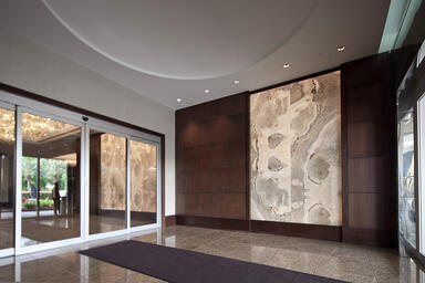 Backlit wall shown in ViviStone Pearl Onyx glass with custom interlayer