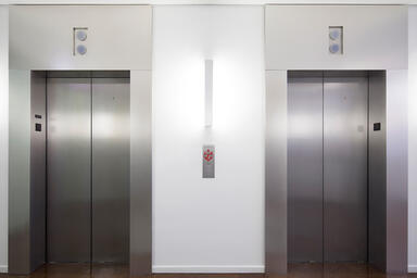 Elevator doors and transoms in Stainless Steel with Sandstone finish