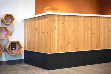 Reception desk accent panel in Bonded Quartz, Charcoal, with Loft pattern