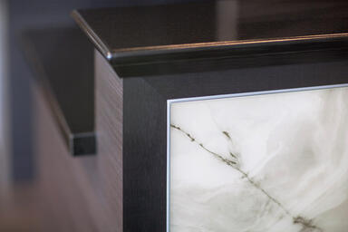 Reception desk with LightPlane Panels shown in ViviStone White Onyx glass