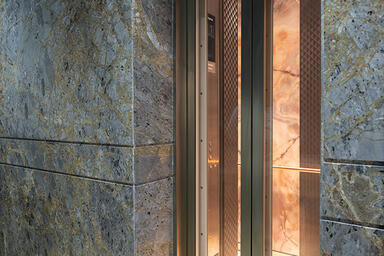 Custom Elevator Doors, transom, and door jambs in Fused White Gold with Seastone