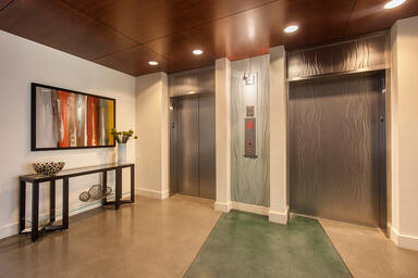 Elevator doors and transoms shown in Stainless Steel with Seastone finish 