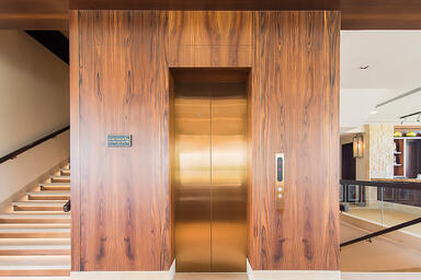 Elevator doors shown in Fused Bronze with Satin finish 