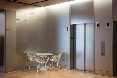 Wall panels and elevator doors shown in Fused White Gold with Seastone finish 