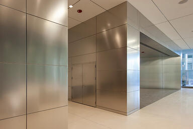 LEVELe Wall Cladding System with Float panels and custom panels in Stainless