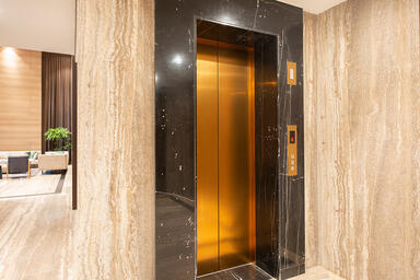 Elevator Doors in Fused Bronze with Linen finish at Verde Residence Collection, 